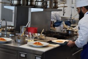Participant of the cooking competition preparing food