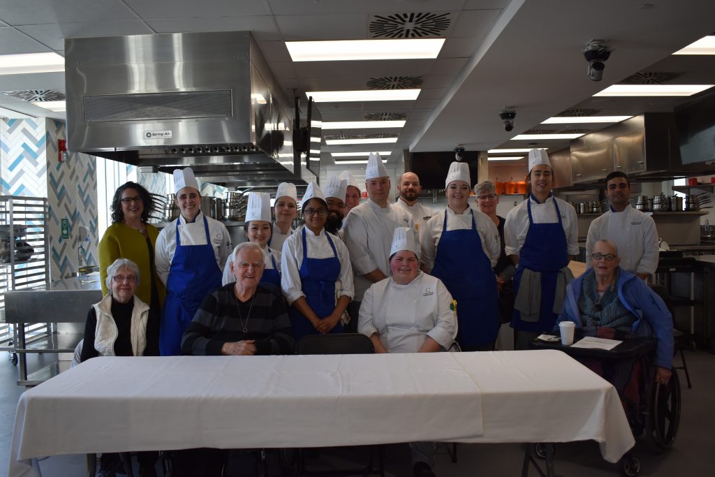Group photo of the cooking competition judges and participants